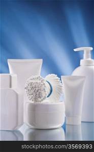 set of white skincare accessories o0n blue background