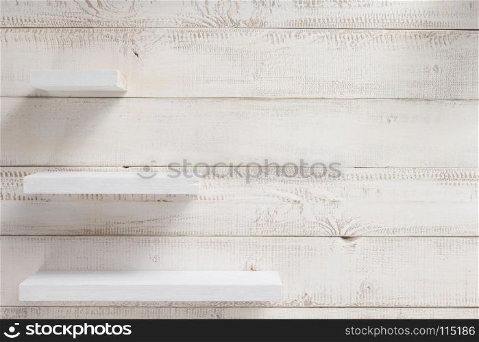 set of wooden shelves at white plank background texture
