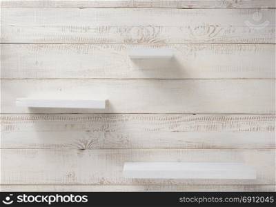 set of wooden shelves at white plank background texture