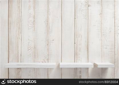 set of wooden shelves on white wall background texture