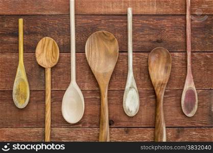 set of wooden spoons against a rustic barn wood table