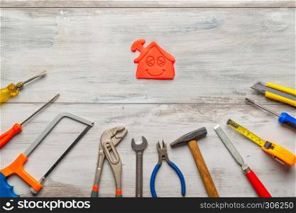 Set of work tool on gray wooden background with icon of house in space, industry engineer tool concept.
