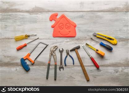 Set of work tool on rustic wooden background with icon of house in space, industry engineer tool concept.