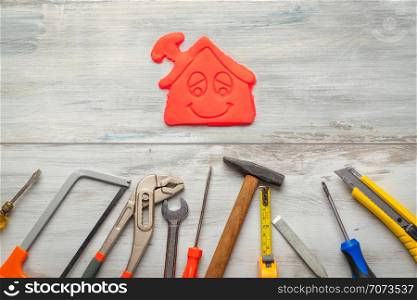 Set of work tool on rustic wooden background with icon of house in space, industry engineer tool concept.still-life.