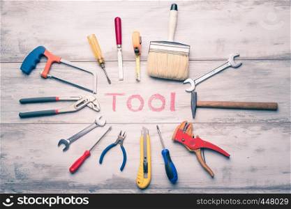 "Set of work tool on rustic wooden background with written "tool" in space, industry engineer tool concept.still-life.close up."
