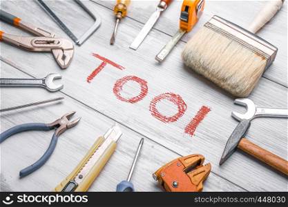 "Set of work tool on rustic wooden background with written "tool" in space, industry engineer tool concept.still-life.close up."