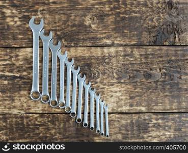 set of wrench against old wooden boards background