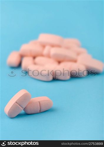 set red tablets on blue background. Photo closeup