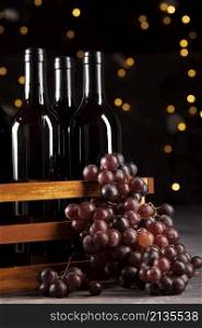 set wine bottles grapes with bokeh background
