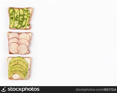 Set with toast bread and different toppings on white background, top view. Copy space. Healthy snack or vegan food concept. Set with toast bread and different toppings on white background, top view