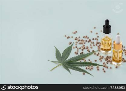 Sets of legalized marijuana features with CBD oil in bottle with dropper lid, sativa green hemp, and hemp seeds. Cannabis product for copyspace and advertisement.. Sets of legalized marijuana features with CBD oil in bottle with dropper lid.