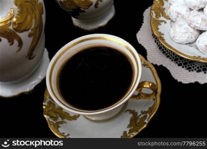 Setting of a cup of Coffee in antique porcelain with cookies
