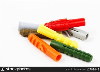 seven colorful rawl plugs. seven colorful rawl plugs on white background