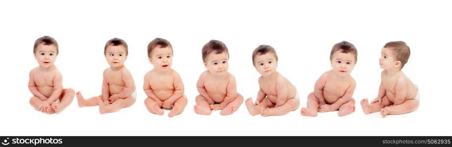 Seven equal babies sitting on the floor isolated on a white background