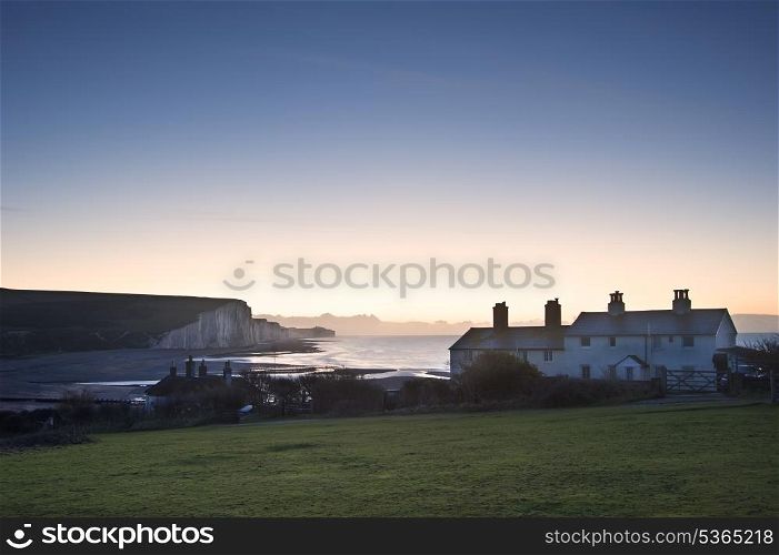 Seven Sisters cliffs at sunrise with coastguard cottages if foreground at Seaford Head