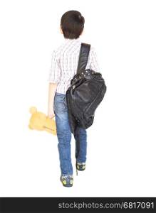 Seven year old Asian boy with a bag is ready to go to school isolated over white