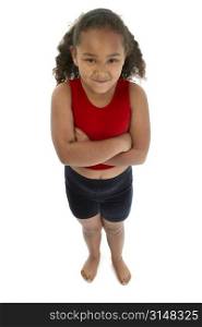 Seven year old girl in workout clothes standing with arms crossed.