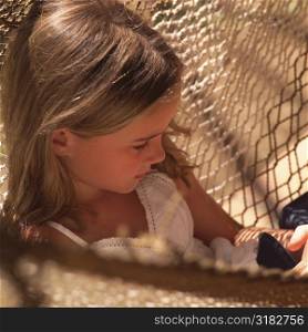 Seven year old girl sitting in a hammock