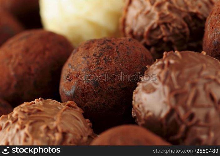 Several assorted gourmet chocolate truffles close up