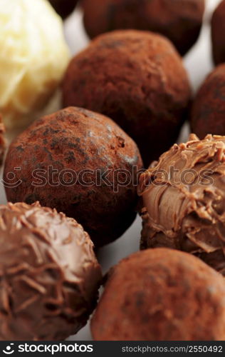 Several assorted gourmet chocolate truffles close up