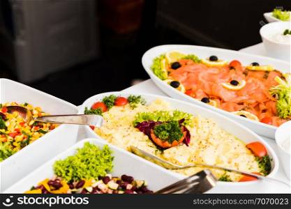 Several dishes with various salads in buffet restaurant