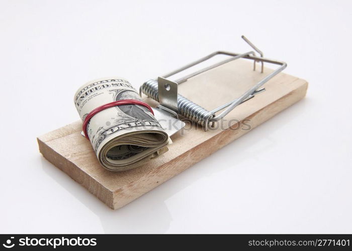several dollar bills with elastic band set on a mouse-trap