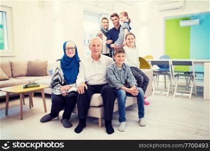 several generations portrait of happy modern muslim family before iftar dinner during ramadan feast at home