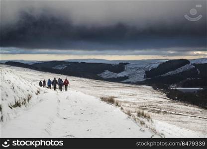 Several hikers in stormy winter landscape in Brecon Beacons. Landscapes. Hikers in stormy winter landscape in Brecon Beacons