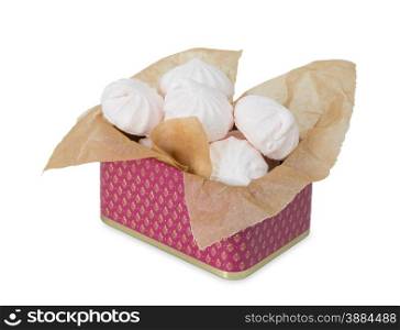 Several meringues in the square tin box in the packaging paper isolated on white background