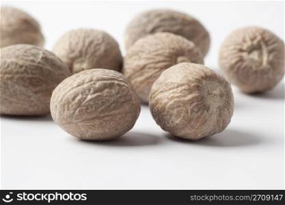 Several Nutmeg on a white background