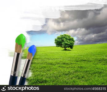 several paintbrushes and nature landscape on the background