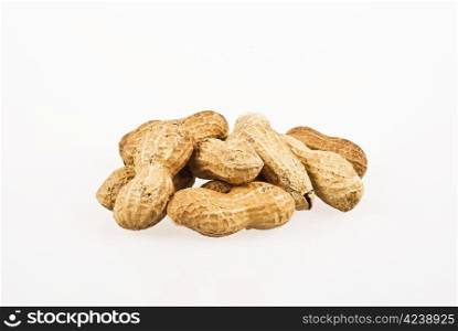 Several peanuts in shells over white background