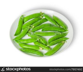 Several pods of peas on a white plate isolated on white background