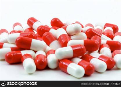 Several red and white pills of medicine on white background with free space. Various red and white pills on white background