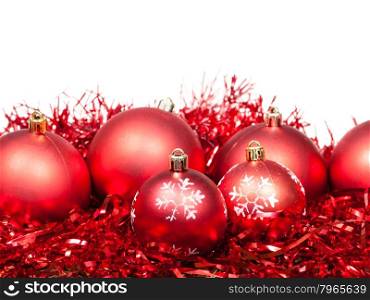 several red Christmas balls and tinsel isolated on white background