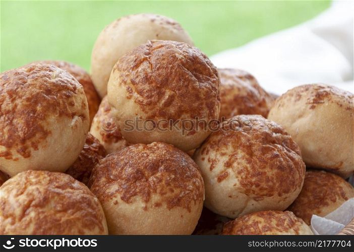 several small loaves of bread in a basket, on a buffet table