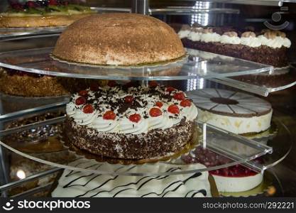 Several Types of Stuffed Cakes inside a Pastry Display Stand.. Several Types of Stuffed Cakes inside a Pastry Display Stand