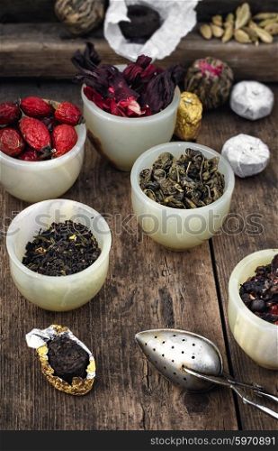 Several varieties of tea leaves. Different varieties of tea leaves in bowl of custard and spoon