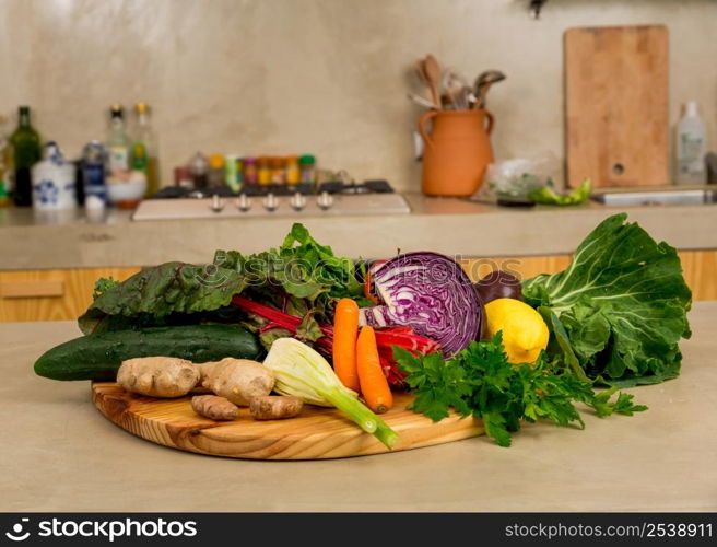 Several vegetables on top of a wooden board. Ingredients for detox diet.