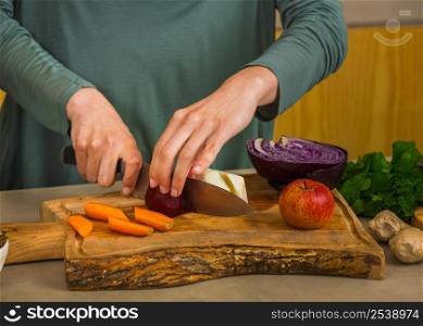 Several vegetables on top of a wooden board. Ingredients for detox juice.
