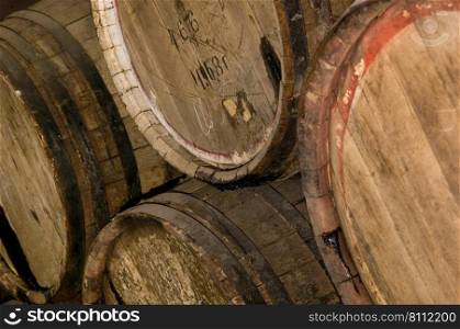 Several wooden barrels with wine closeup. wooden wine barrels