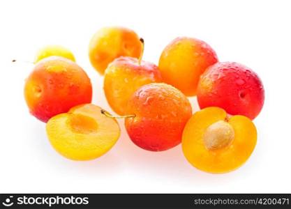 Several yellow plums isolated on white background