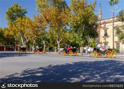 Seville. Horse ride around the city.. Seville, Spain - October 29, 2016: Walking in horse carriages around Seville. One of the most popular tourist attractions.