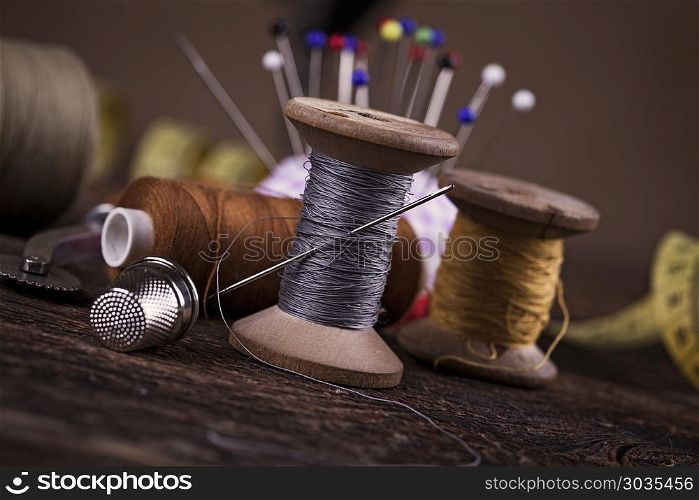 Sewing instruments, threads, needles, bobbins and materials.. Sewing instruments, threads, needles, bobbins and materials. Studio photo