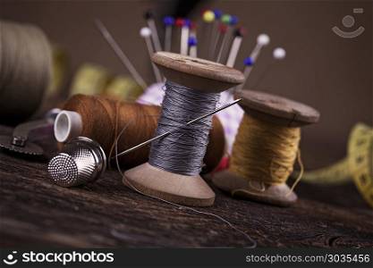 Sewing instruments, threads, needles, bobbins and materials.. Sewing instruments, threads, needles, bobbins and materials. Studio photo