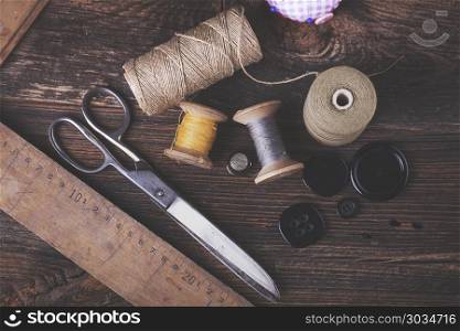 Sewing instruments, threads, needles in vintaae style. Sewing instruments, threads, needles, bobbins and materials. Studio photo