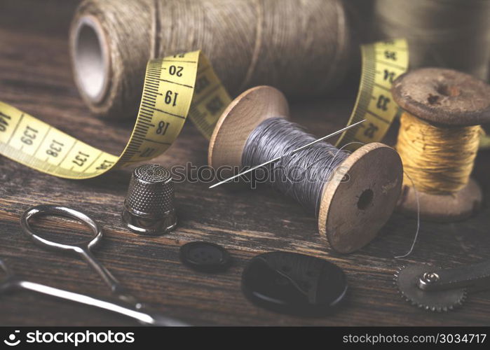 Sewing instruments, threads, needles in vintaae style. Sewing instruments, threads, needles, bobbins and materials. Studio photo