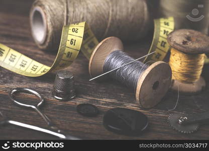 Sewing instruments, threads, needles in vintaae style. Sewing instruments, threads, needles, bobbins and materials. Studio photo