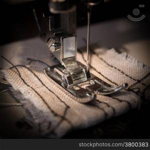Sewing machine and a linen rag. Focus on the needle.