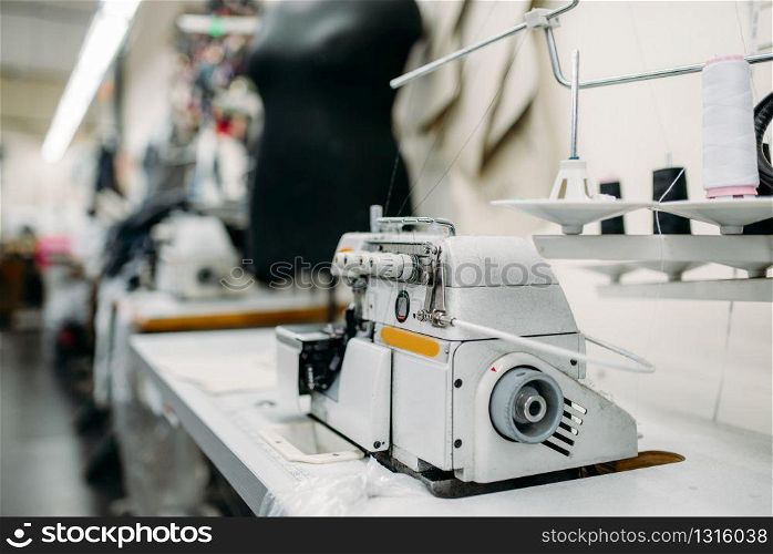 Sewing machine on clothing factory, nobody. Dressmaking industry, Equipment on dress fabric, tailoring